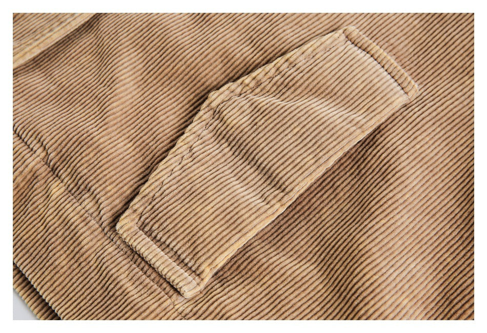 Close-up of a rectangular patch pocket on tan corduroy fabric.