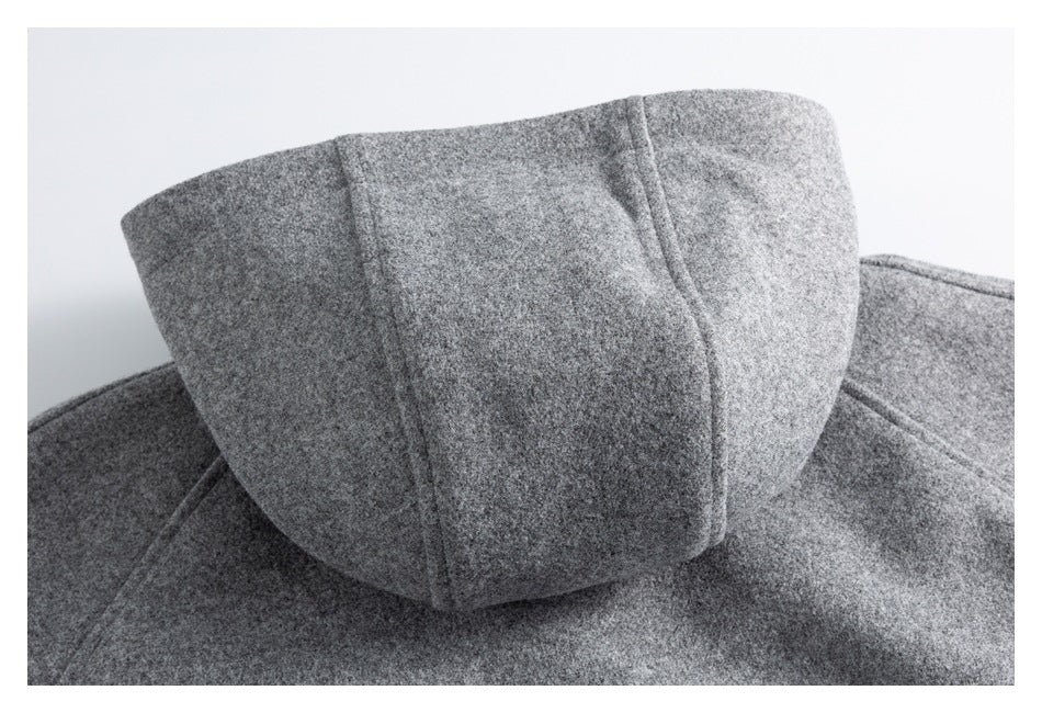 Close-up of the gray coat's hood and stitched panel seams.