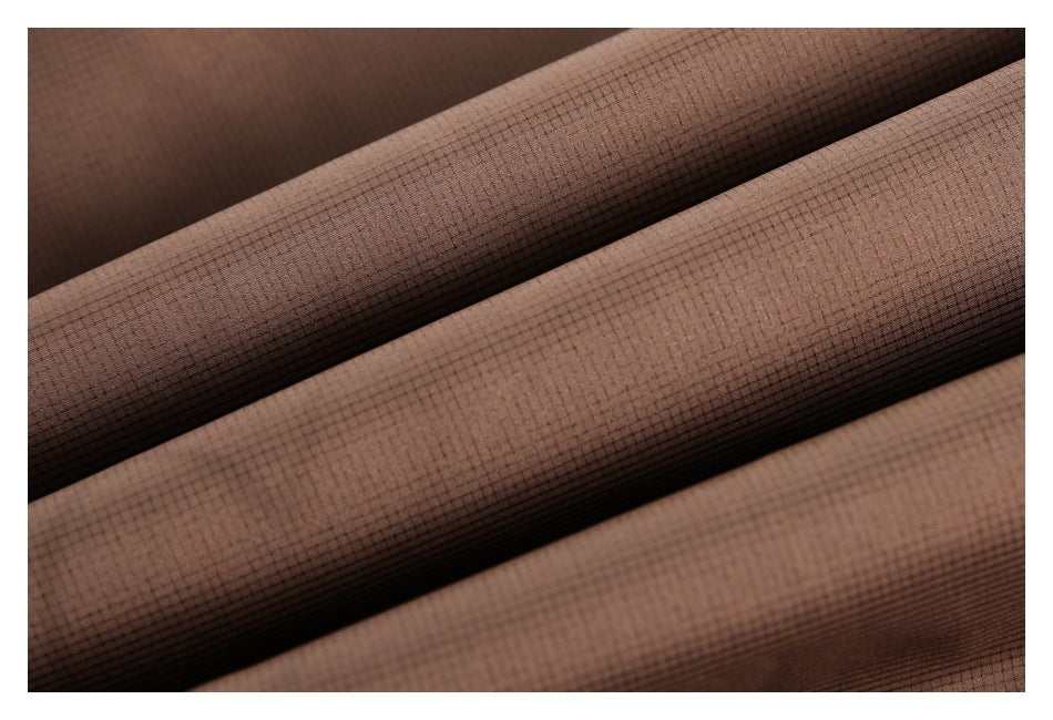Macro view of brown fabric with a fine, subtle grid pattern.