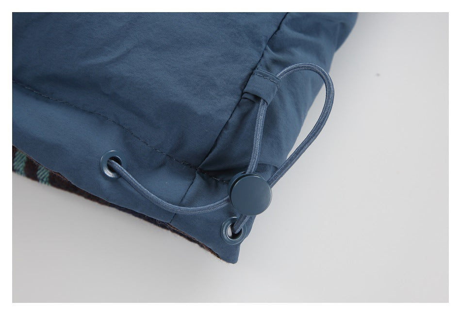 Close-up of the jacket hem's adjustable drawcord, eyelets, and toggle.