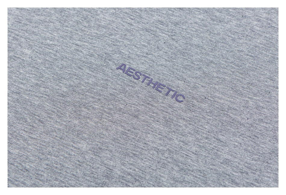 Close-up of heather gray fabric with purple “AESTHETIC” lettering.