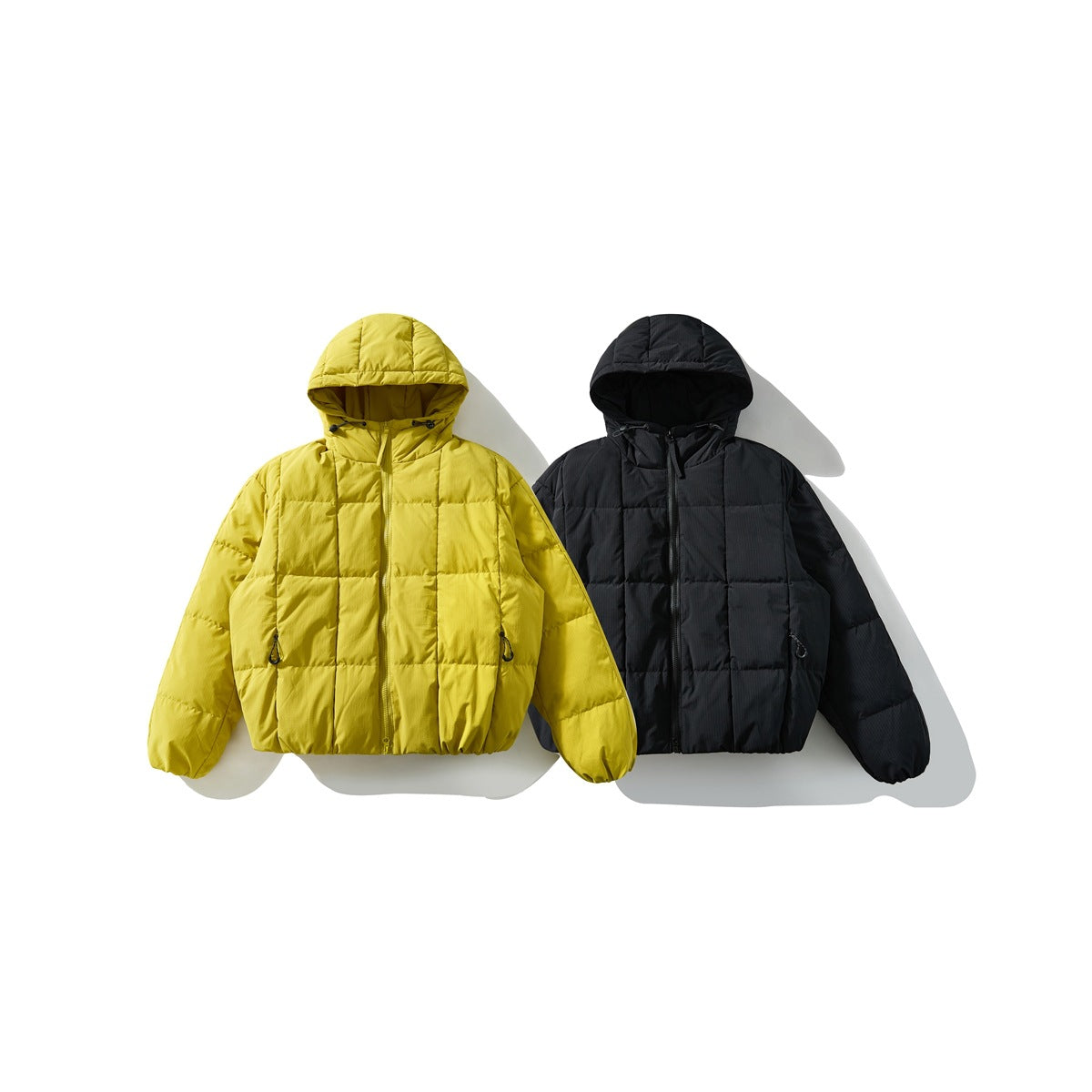 Two hooded quilted jackets displayed side by side in yellow and black.