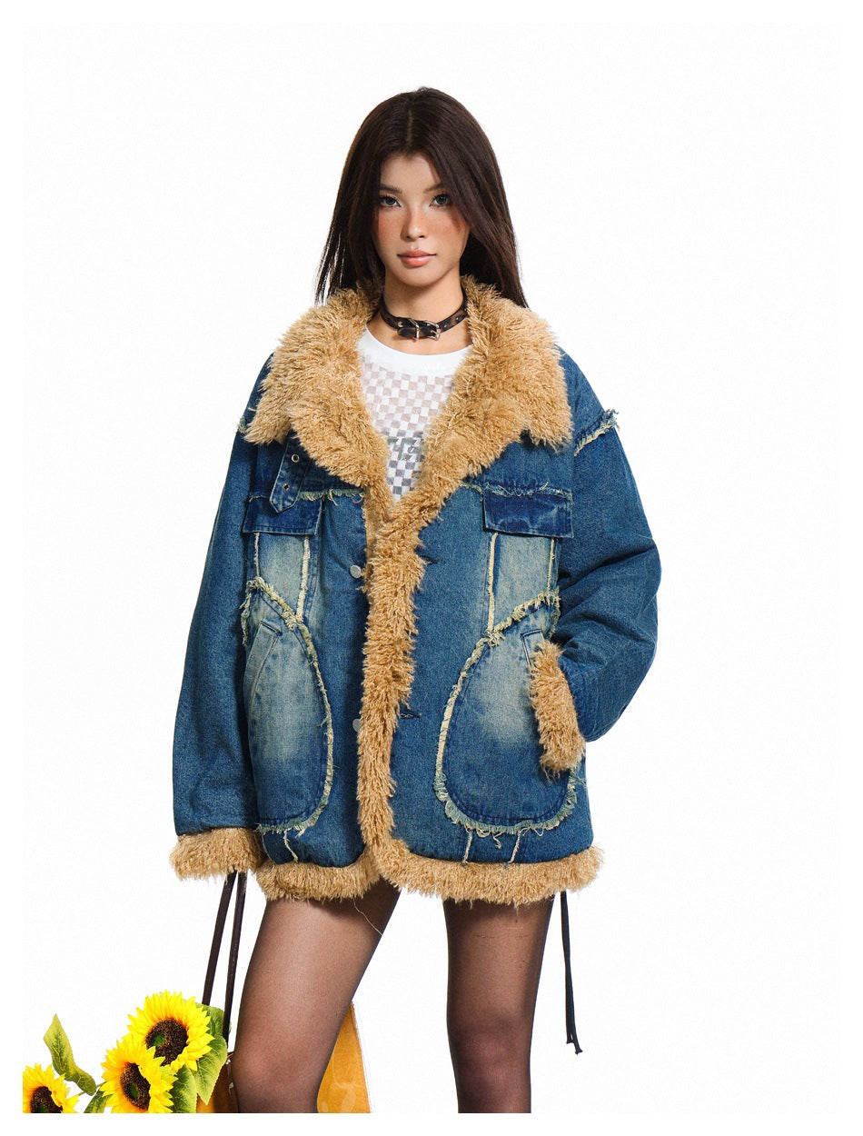 Model wearing a blue denim jacket with tan fleece-like collar and trim over a white mesh top, front view