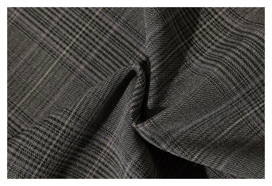 Close-up of gray plaid fabric gathered into folds, with thin muted purple lines in the pattern.