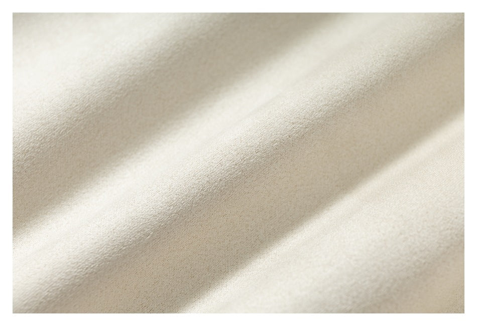 Close-up showing the softly textured surface of ivory fabric.