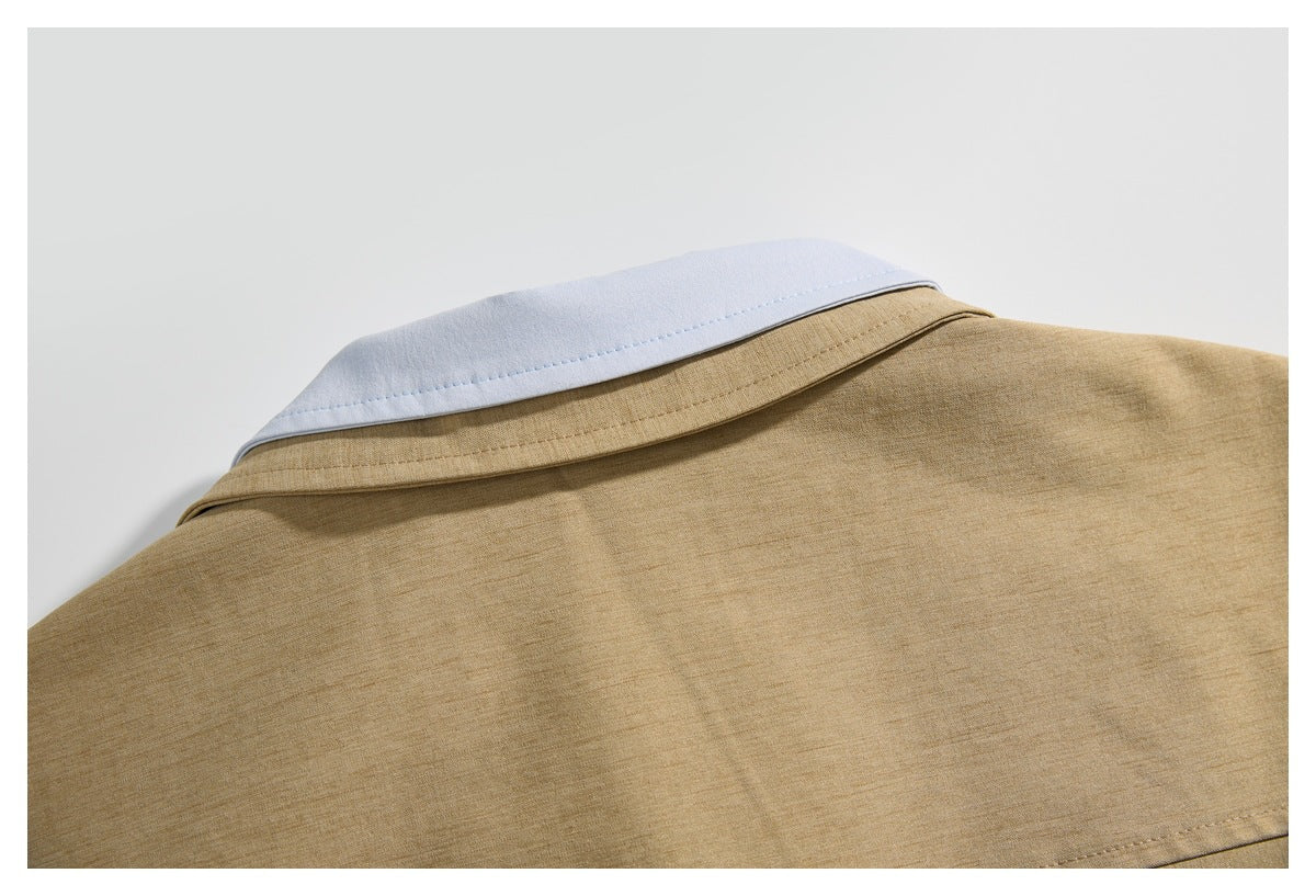 Close-up of the back collar and shoulder area of a tan jacket, showing a contrasting white collar insert.