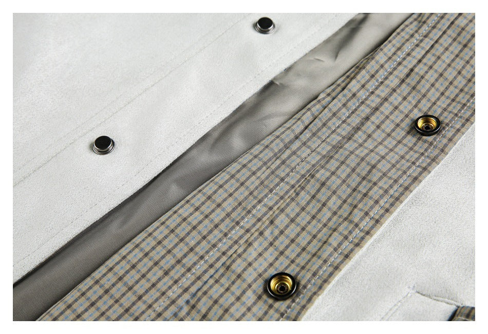 Close-up of a beige-and-blue plaid jacket placket beside light gray fabric, with metal snap buttons.