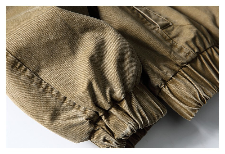 Close-up of gathered elastic cuffs on a tan-brown jacket sleeve.