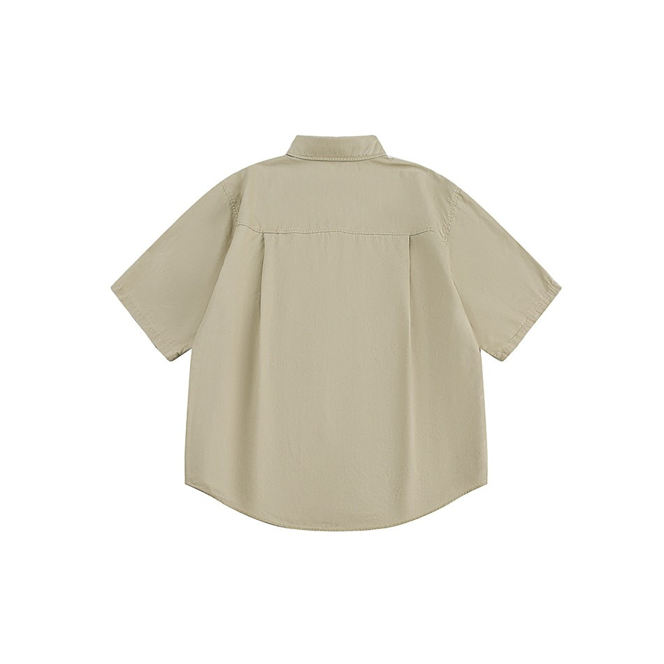 Back view of a beige short-sleeve button-up shirt with a pointed collar and curved hem, on a white background.