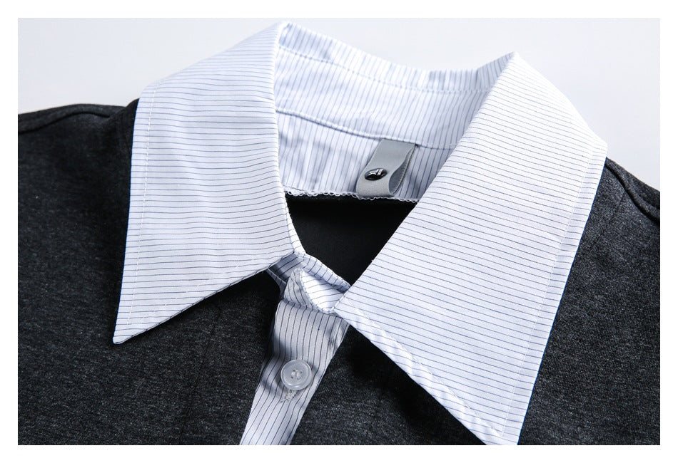Close-up of a white pinstriped collar and button placket on a charcoal top.