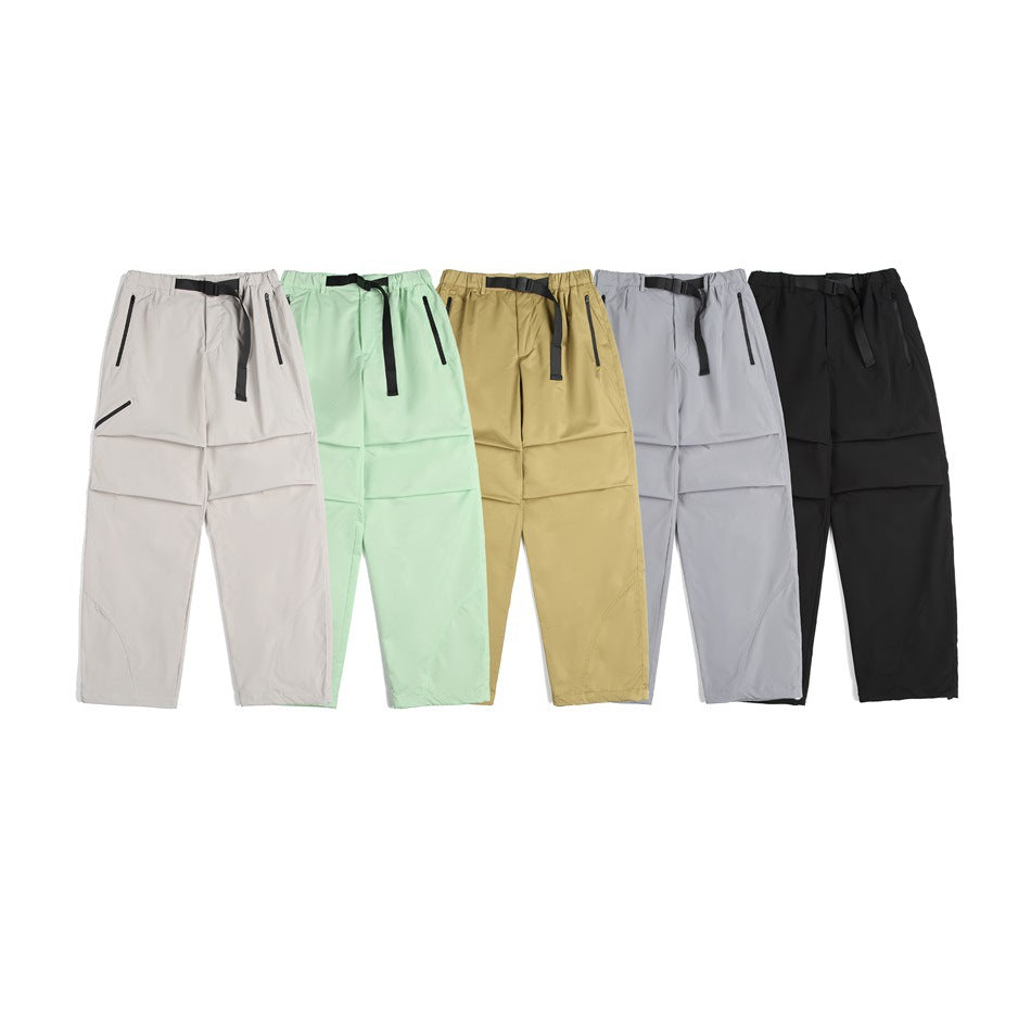 Five pairs of loose pants shown together in light beige, mint green, mustard, gray, and black.