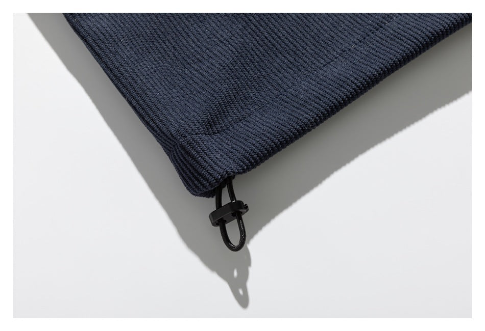 Close-up of the navy jacket hem with a black elastic drawcord and toggle.