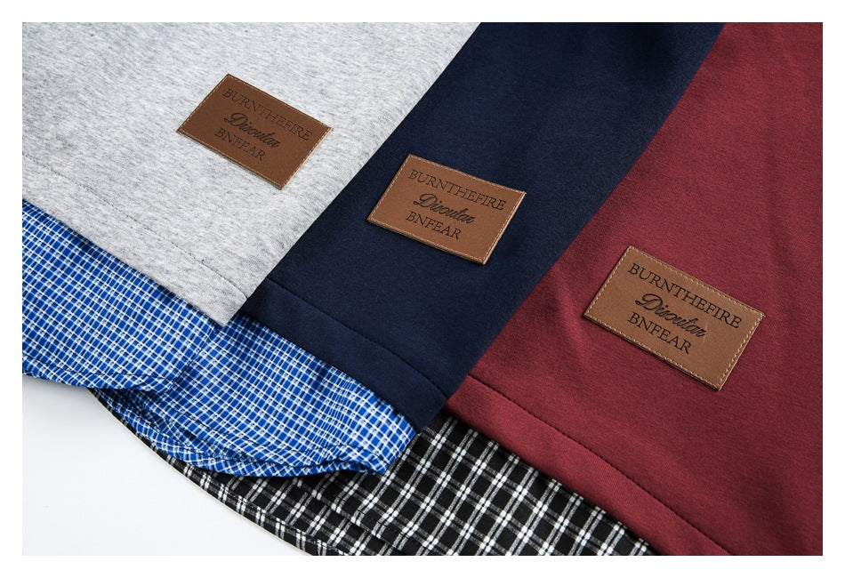 Close-up of gray, navy, and burgundy garment panels with plaid fabric sections and brown rectangular patches.
