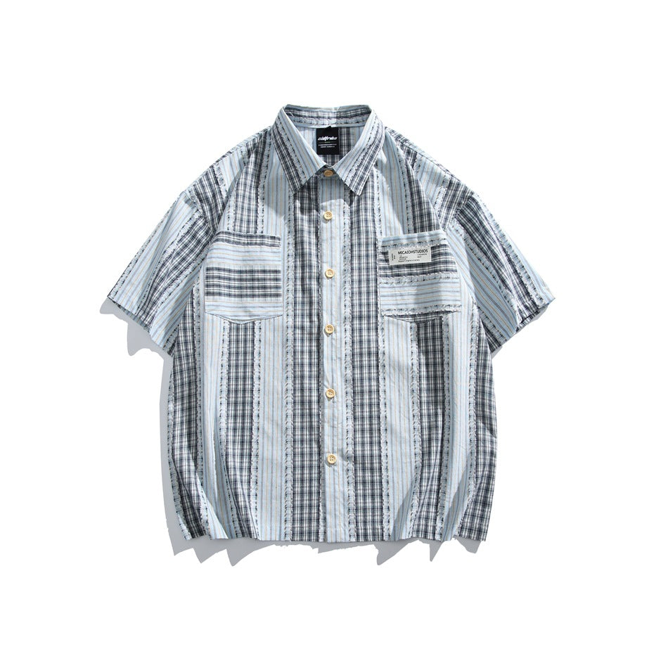 Blue-gray plaid and light blue pinstripe short-sleeve button-up shirt with chest pockets, flat lay front view