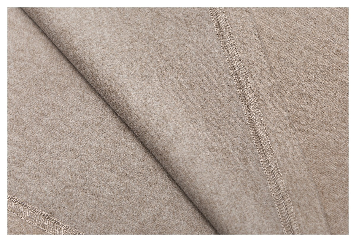 Close-up of the taupe garment's interior overlocked seams and fabric surface.