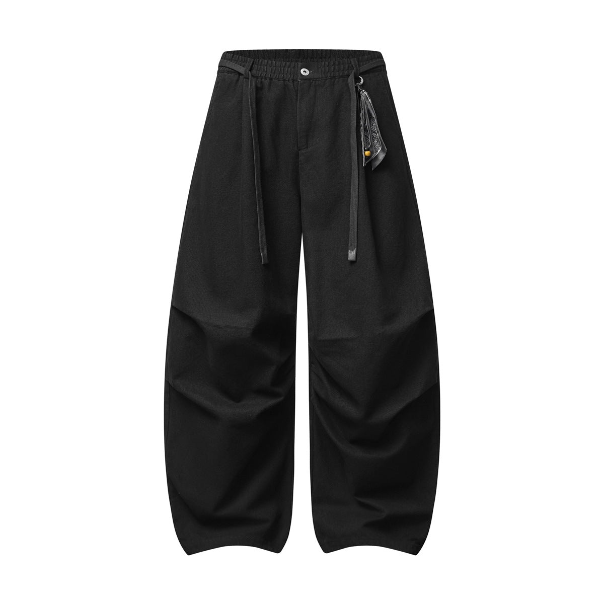 Black wide-leg pants with elastic waist, drawstring tie, button front, knee pleats and a hanging scarf charm
