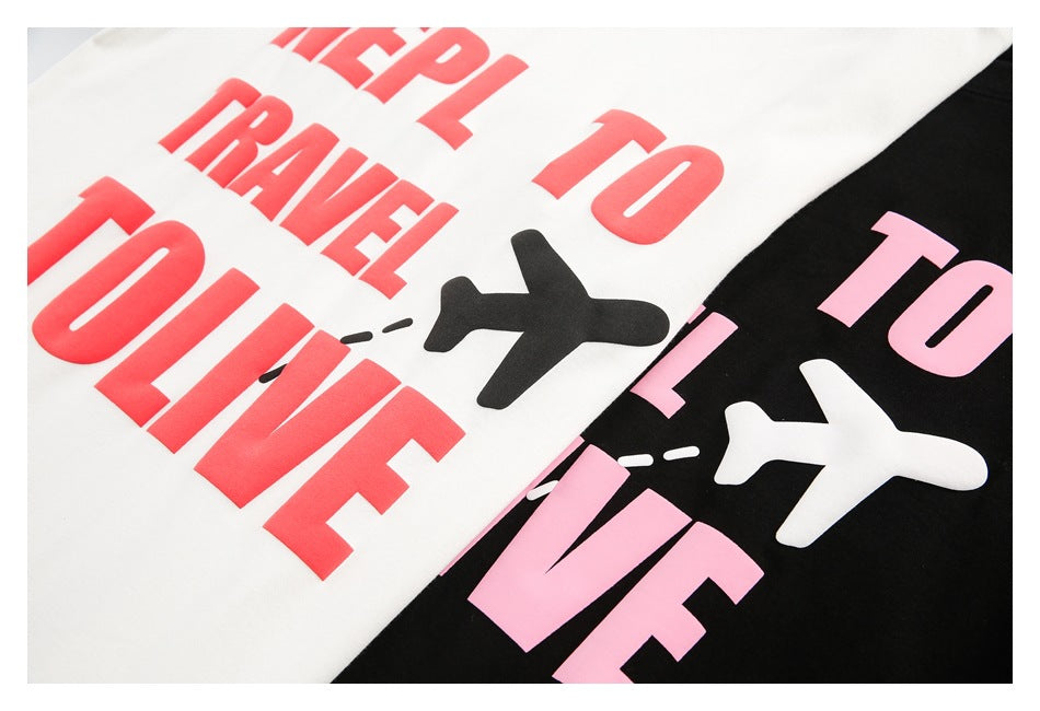 Close-up of white and black shirts with bold contrasting text and airplane graphics.
