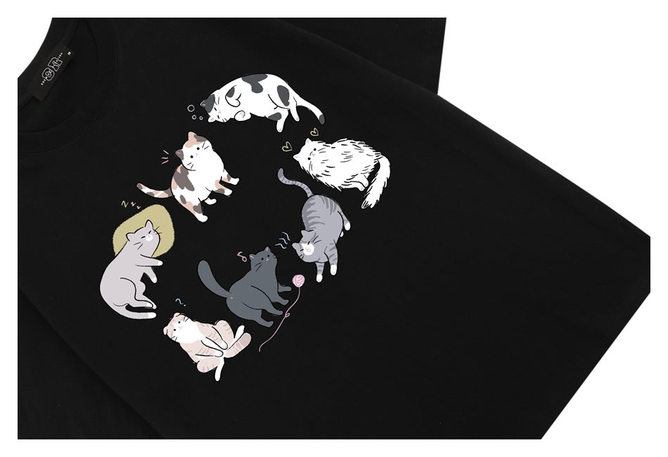Black T-shirt with a colorful circular arrangement of illustrated cats on the chest.