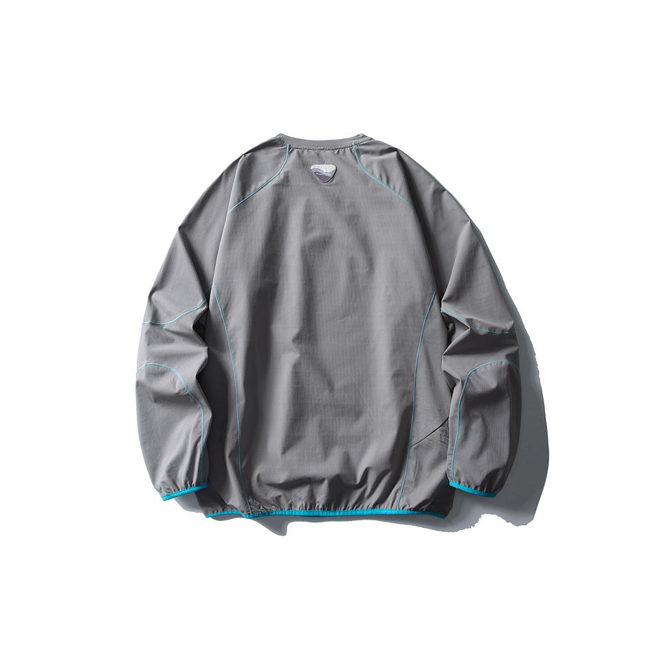 Back view of a gray long-sleeve pullover with turquoise seam piping and trim, plus a small triangular neck patch.