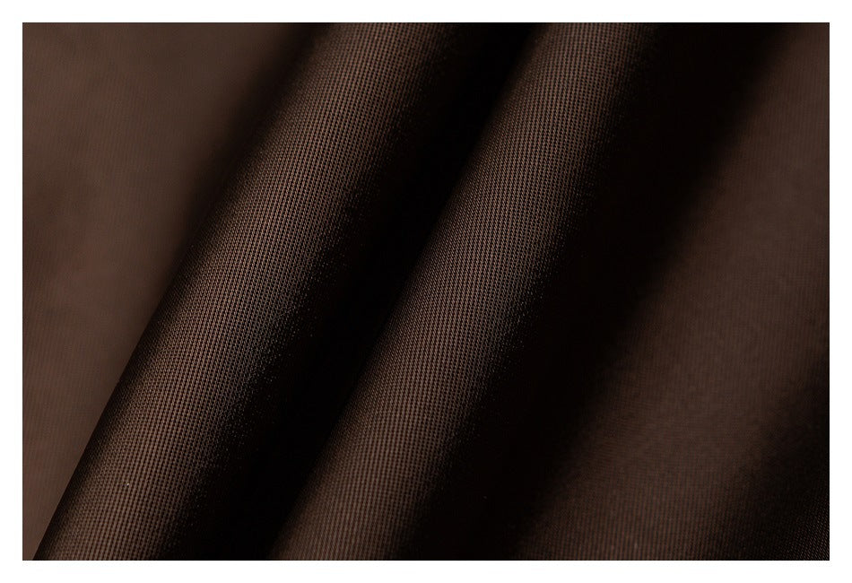 Close-up of dark brown fabric texture draped in soft folds.