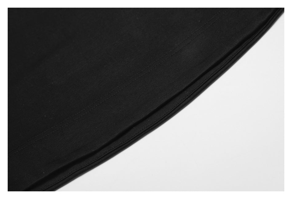 Close-up of the black shirt's curved hem and parallel stitching.