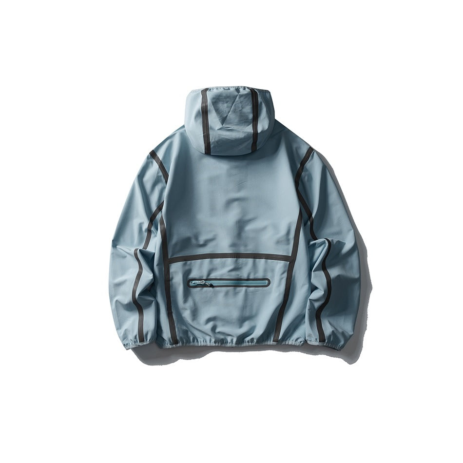 Back view of a pale blue hooded jacket with dark contrast seam trim and a horizontal zip pocket.