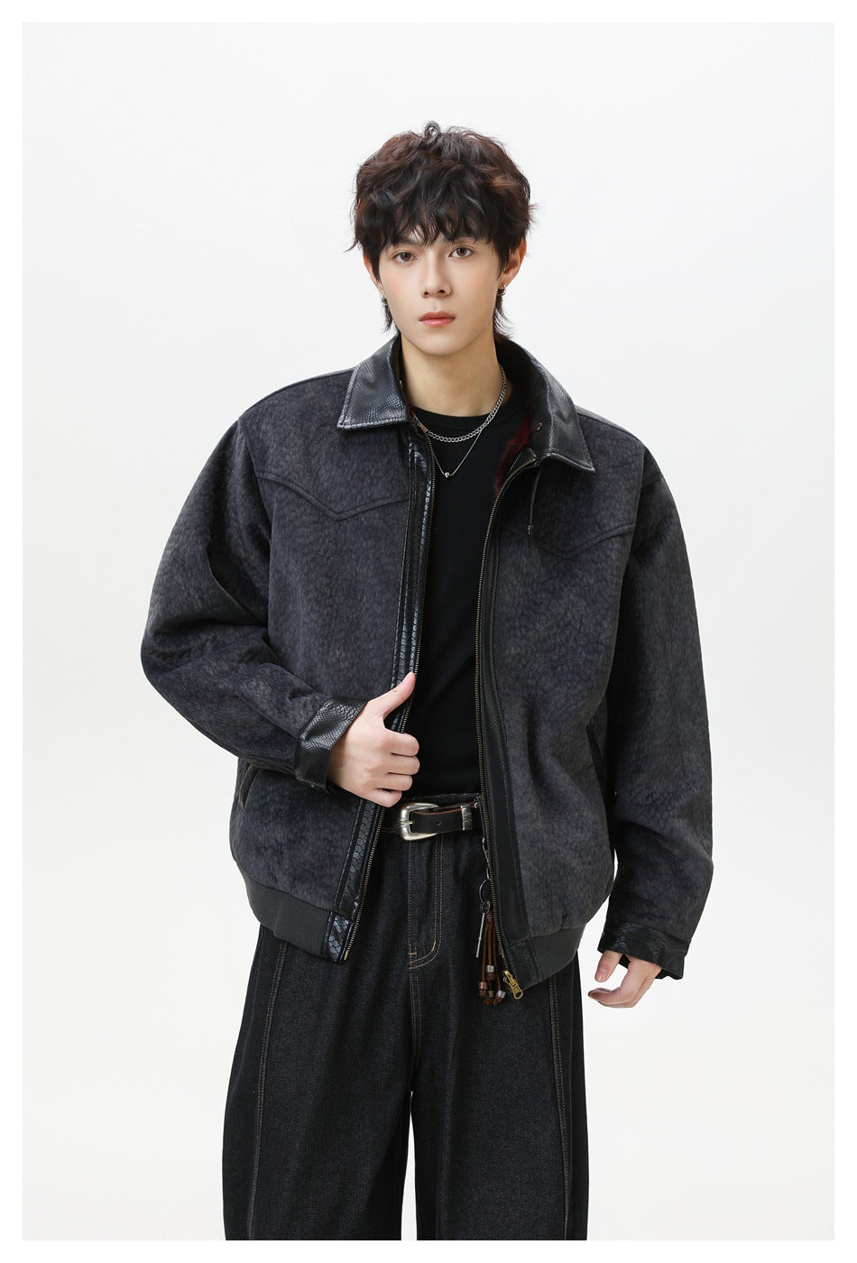 Man wearing charcoal gray zip jacket with black textured collar over black tee and dark wide-leg jeans