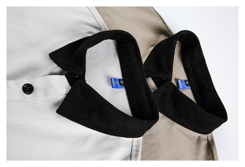 Close-up of white and beige button-up shirts with black collars and visible buttons.