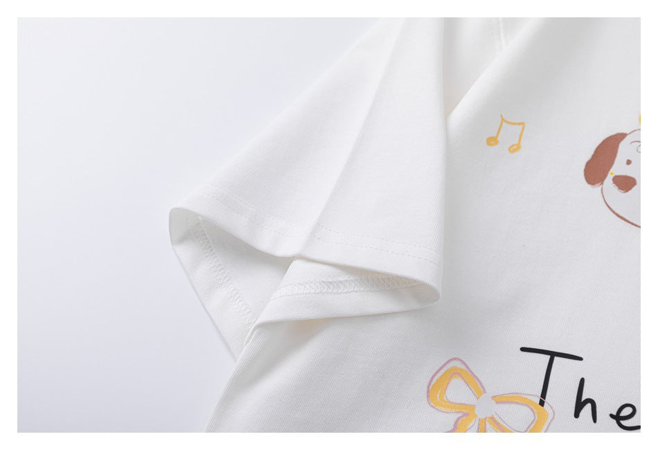 Close-up of the white T-shirt’s short sleeve and stitched hem, with part of the colorful front print visible.