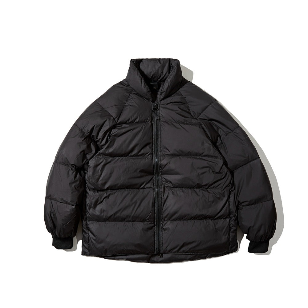 Front view of a black quilted puffer jacket with a high collar, center zipper, and ribbed cuffs.