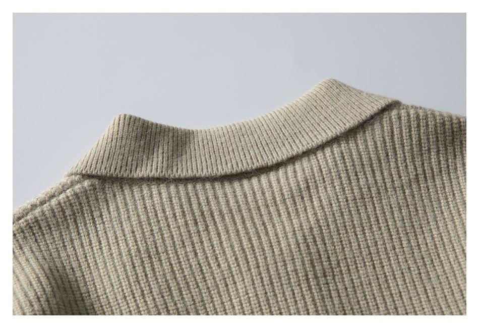 Close-up of the beige rib-knit garment's folded collar and upper body.