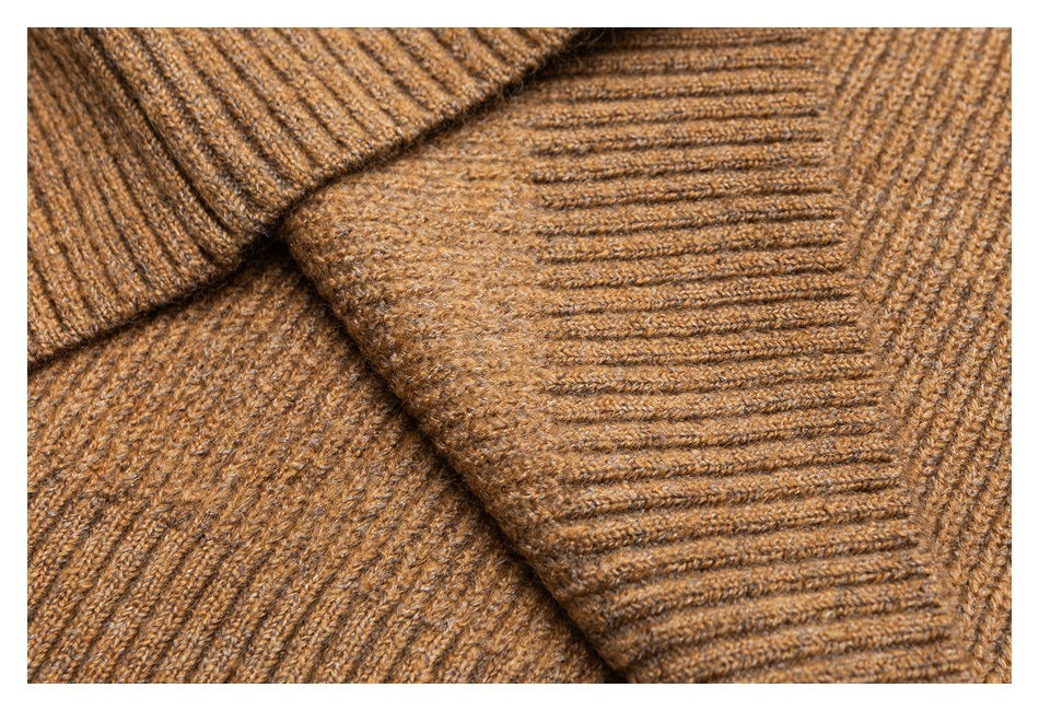 Close-up of camel-brown knit fabric showing ribbed edges and a textured stitch pattern.