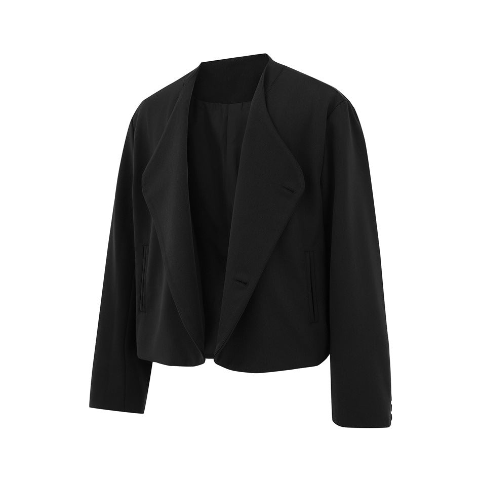 Black cropped jacket with front opened to show the folded lapel-style panel, interior and cuff buttons