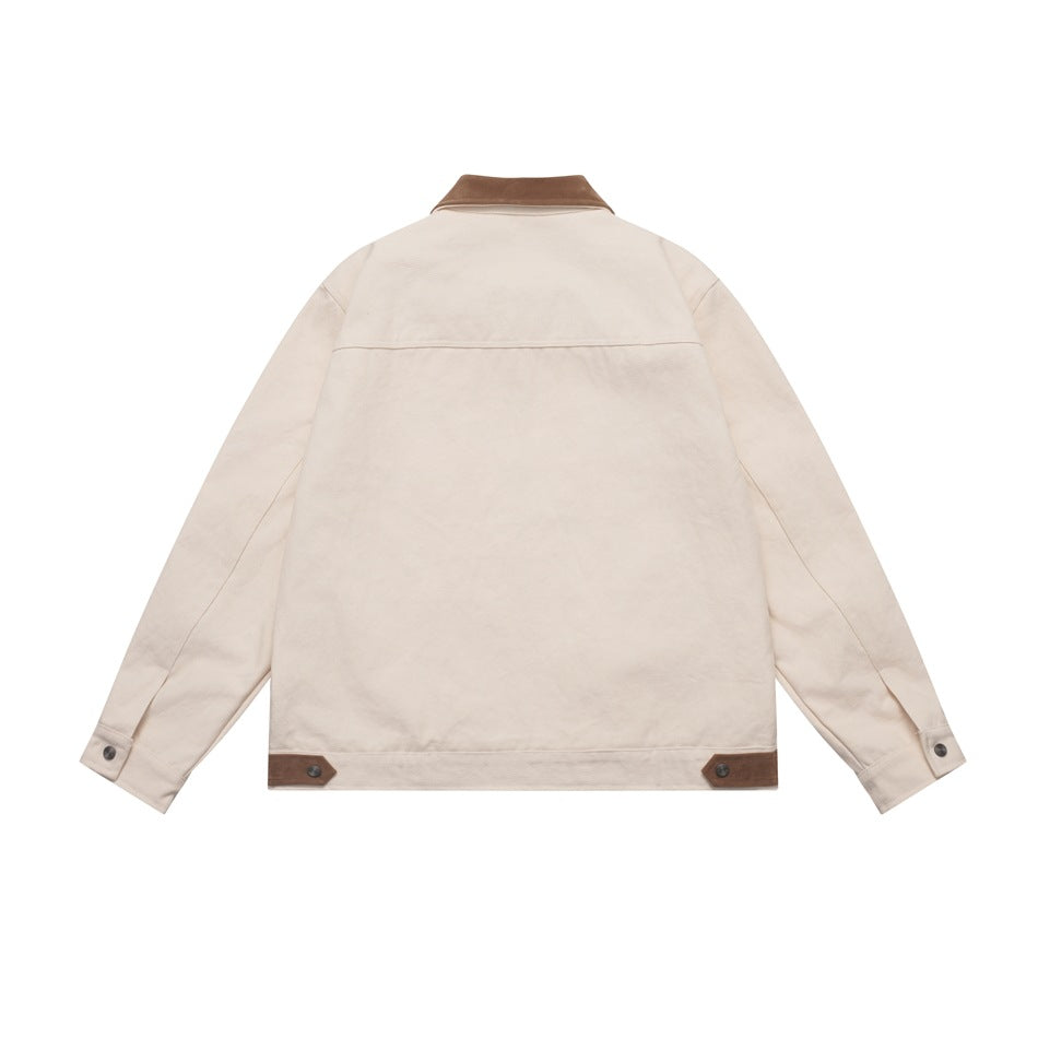 Back view of a cream jacket with a brown collar and brown buttoned tabs at the hem.
