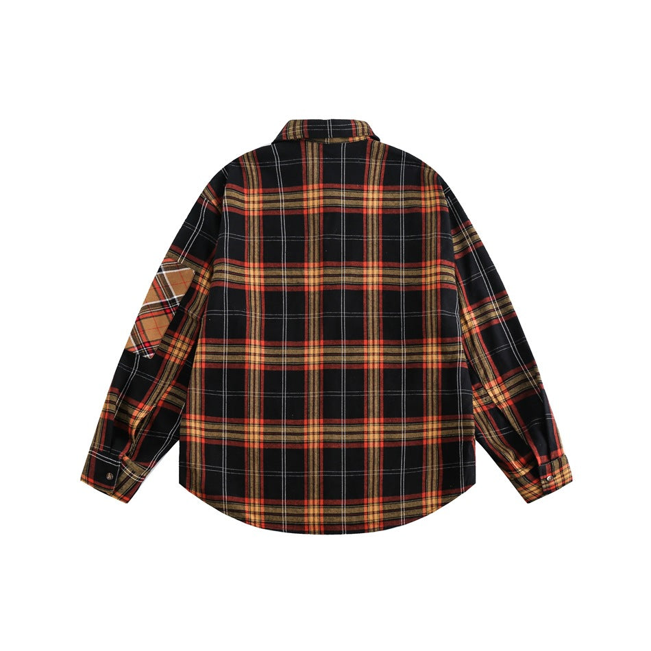 Back of a black plaid button-up shirt with red, mustard, and white stripes and a contrasting patch on one sleeve.