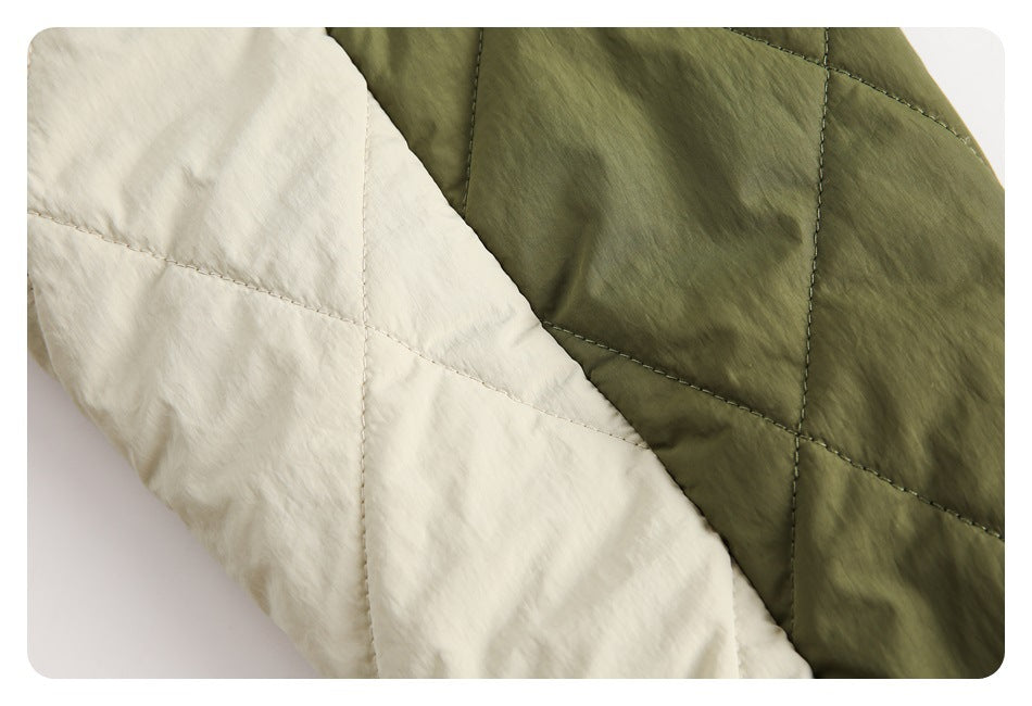 Close-up showing olive and cream panels with geometric quilting on the jacket.