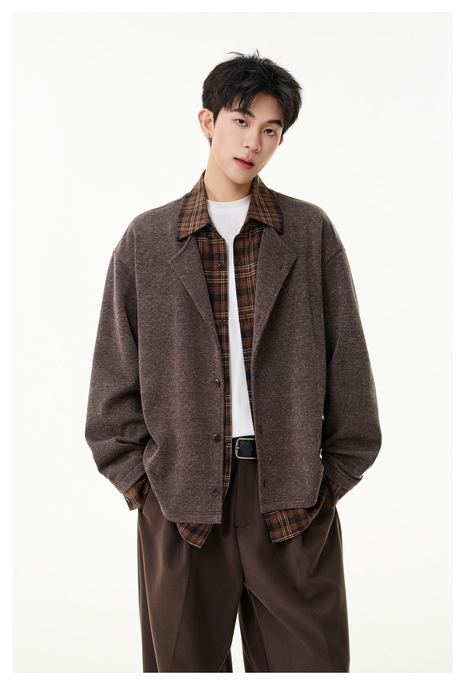 Front view of a model wearing a muted brown button-front jacket over a brown plaid shirt and white tee.