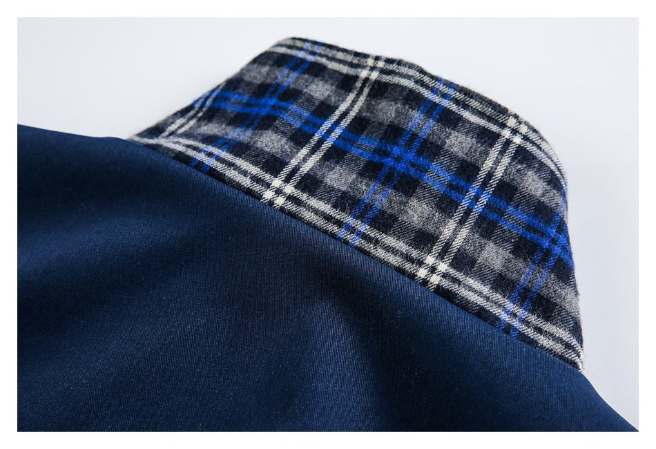 Close-up of a gray, white, and blue plaid fabric panel joined to dark navy fabric.