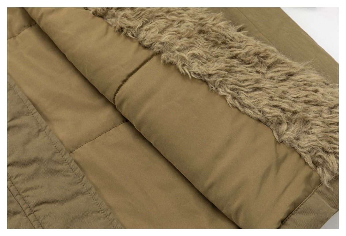 Close-up of a tan quilted garment lining with a thick, shaggy beige trim along the edge.