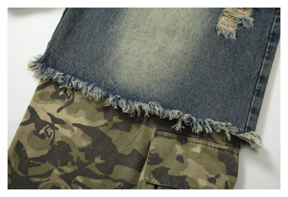 Frayed hem of faded blue denim layered over olive camouflage fabric with a cargo pocket.