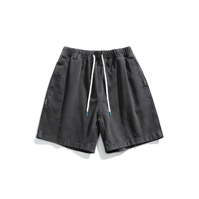 Black gray washed shorts with white drawstring and side pockets, flat lay front view