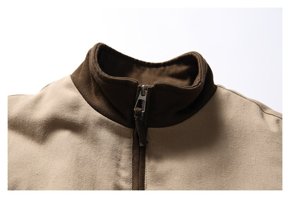 Close-up of the tan jacket's dark brown stand collar and front zipper.