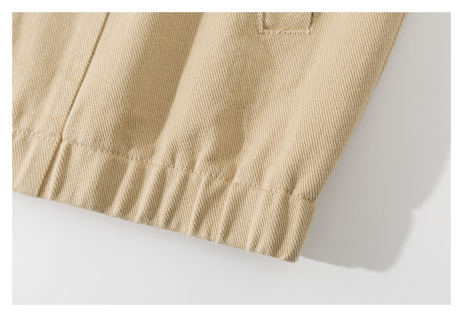 Close-up of the stitched hem and seam on a beige garment.