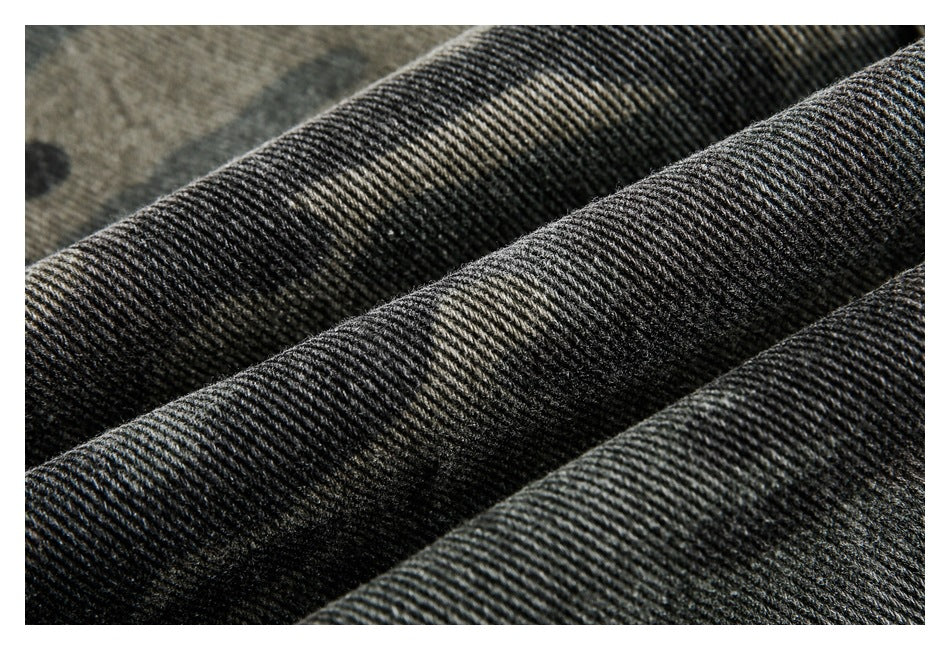 Extreme close-up showing the ribbed diagonal weave of dark camouflage fabric.