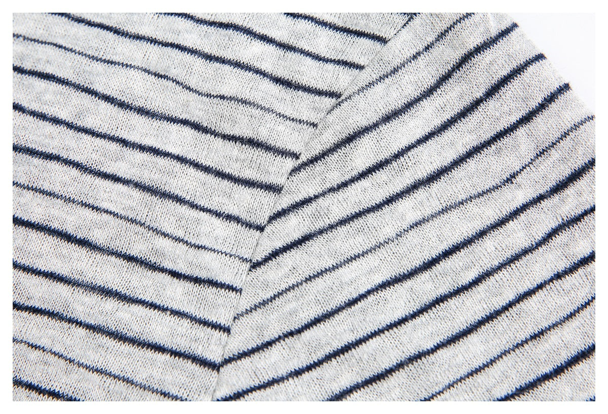 Close-up showing the striped shirt's shoulder seam and aligned stripes.