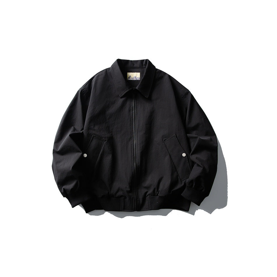 Black zip-front jacket with turn-down collar, snap-detail pockets and ribbed cuffs and hem, flat lay front view