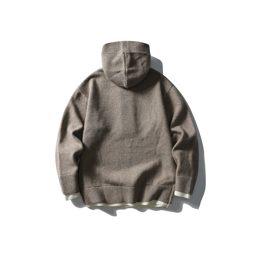 Back view of a taupe hooded knit pullover with ribbed cuffs and hem and cream trim peeking out.