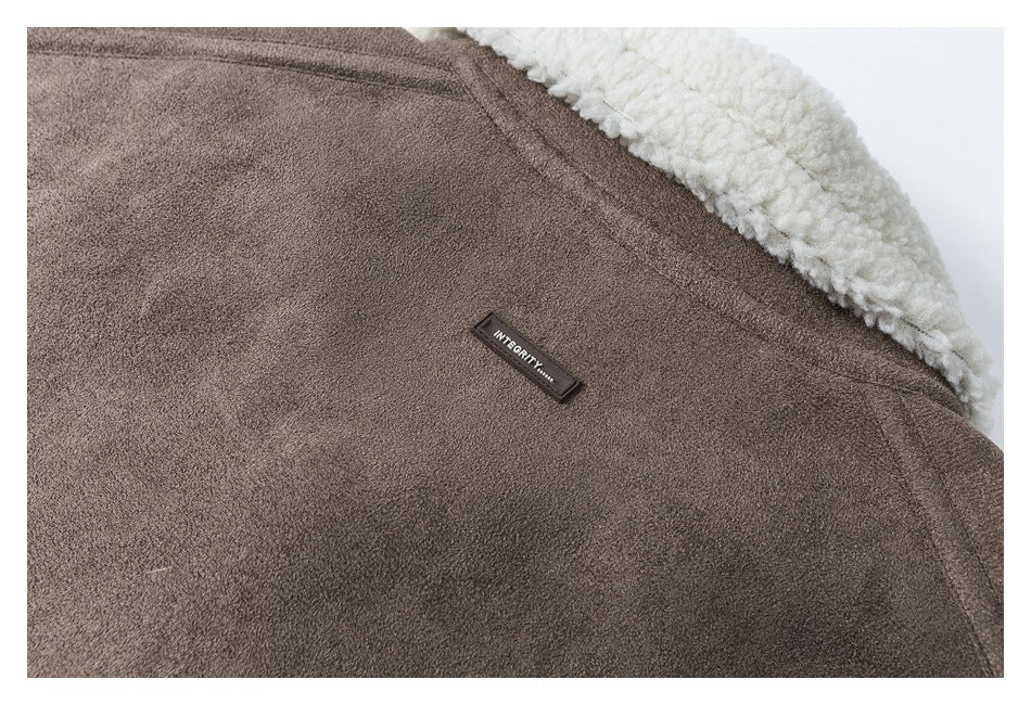 Close-up of a brown jacket with a cream sherpa collar and a small black INTEGRITY label.