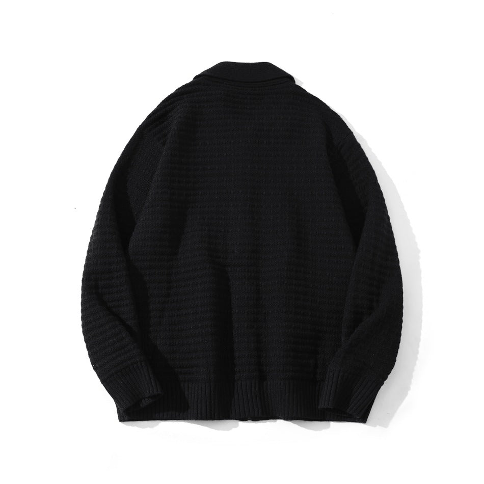 Back view of a black textured cardigan with a wide collar, long sleeves, and ribbed cuffs and hem.