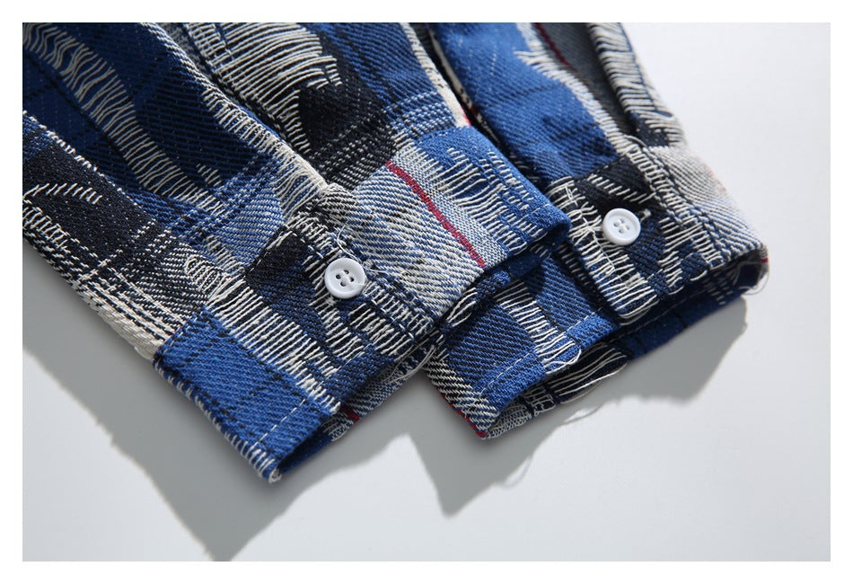 Close-up of two buttoned cuffs on a blue, black, and cream plaid shirt with thin red lines.